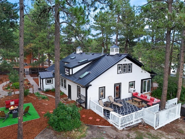 233 Perry Park Ave, Larkspur, CO 80118 - back of property featuring an outdoor living space with a fire pit, a standing seam roof, and a metal roof