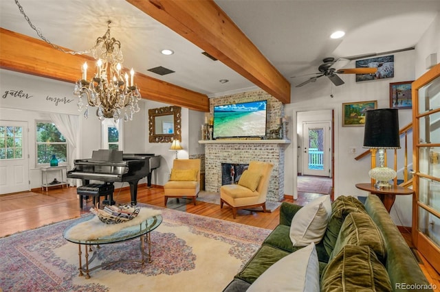 233 Perry Park Ave, Larkspur, CO 80118 - living area featuring wood finished floors, beam ceiling, a chandelier, a brick fireplace, and a ceiling fan