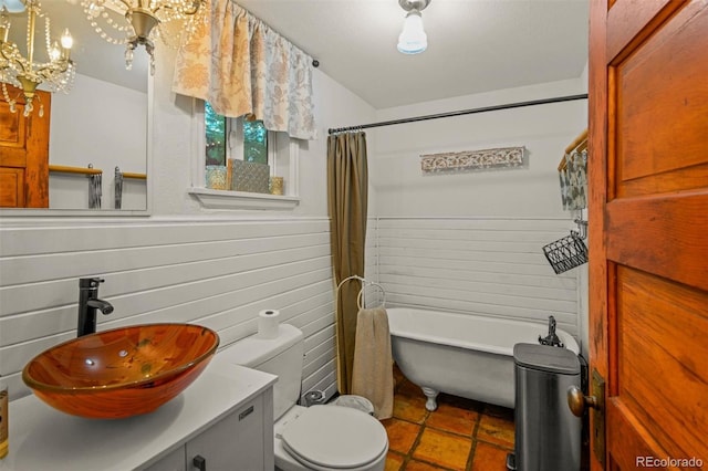 233 Perry Park Ave, Larkspur, CO 80118 - bathroom featuring a chandelier, a freestanding tub, a wainscoted wall, vanity, and a shower with shower curtain