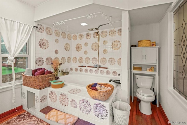 233 Perry Park Ave, Larkspur, CO 80118 - bathroom featuring wood finished floors and tiled shower / bath