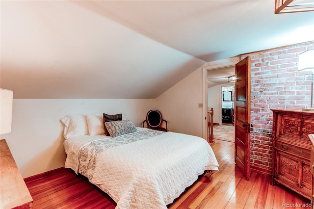 233 Perry Park Ave, Larkspur, CO 80118 - bedroom with wood-type flooring and vaulted ceiling