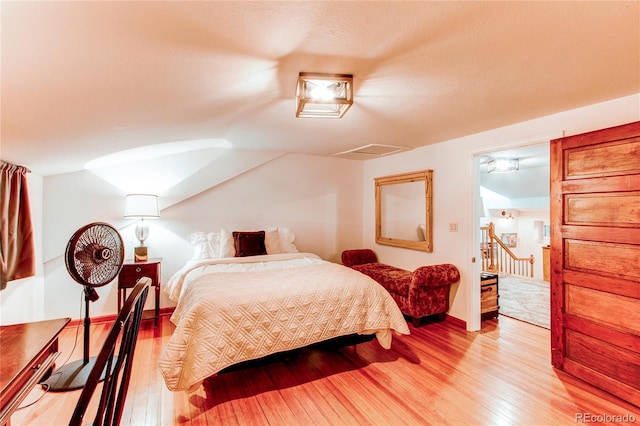 233 Perry Park Ave, Larkspur, CO 80118 - bedroom with light wood finished floors, attic access, and vaulted ceiling