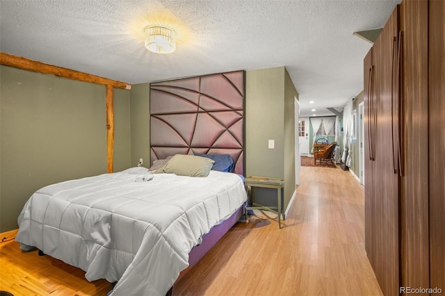 233 Perry Park Ave, Larkspur, CO 80118 - bedroom featuring light wood finished floors and a textured ceiling