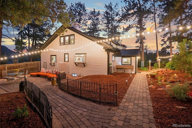 233 Perry Park Ave, Larkspur, CO 80118 - rear view of house with an outdoor hangout area, a fenced backyard, a patio, and cooling unit