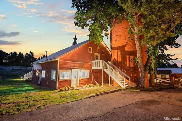 233 Perry Park Ave, Larkspur, CO 80118 - rustic home with stairway and a front lawn