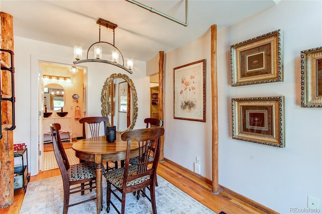 233 Perry Park Ave, Larkspur, CO 80118 - dining area featuring light wood-style flooring and a chandelier