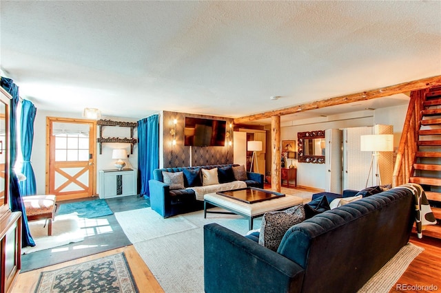 233 Perry Park Ave, Larkspur, CO 80118 - living room with stairs, a textured ceiling, and wood finished floors