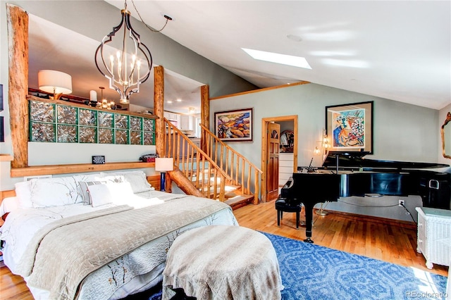 233 Perry Park Ave, Larkspur, CO 80118 - bedroom featuring wood finished floors, a skylight, vaulted ceiling, and a chandelier