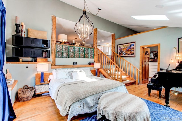233 Perry Park Ave, Larkspur, CO 80118 - bedroom with wood finished floors, lofted ceiling, a chandelier, and a skylight