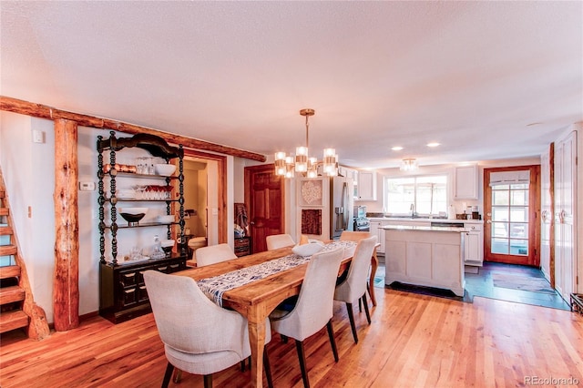 233 Perry Park Ave, Larkspur, CO 80118 - dining area with a chandelier and light wood finished floors