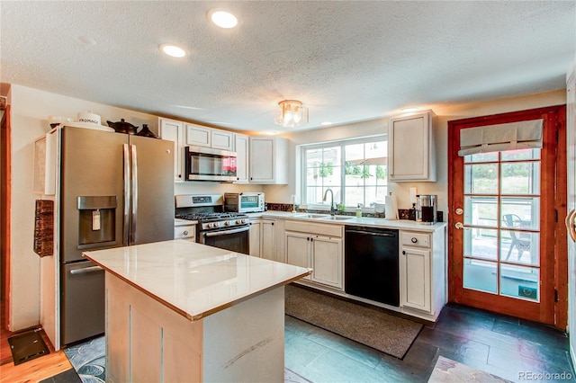 233 Perry Park Ave, Larkspur, CO 80118 - kitchen with appliances with stainless steel finishes, a textured ceiling, a center island, light countertops, and recessed lighting
