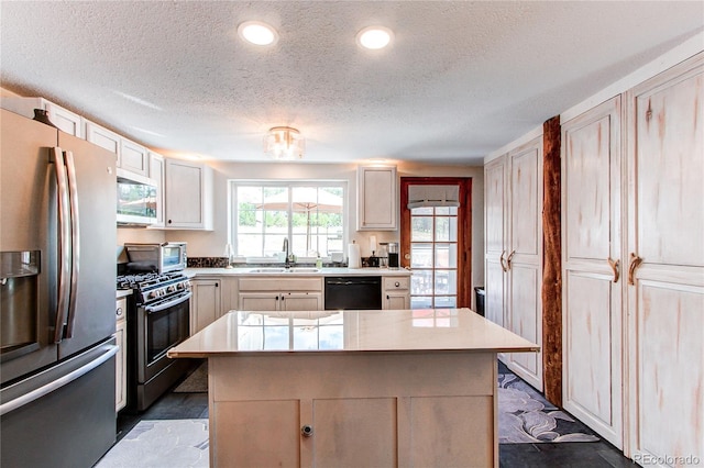 233 Perry Park Ave, Larkspur, CO 80118 - kitchen with stainless steel appliances, light countertops, a textured ceiling, a center island, and recessed lighting