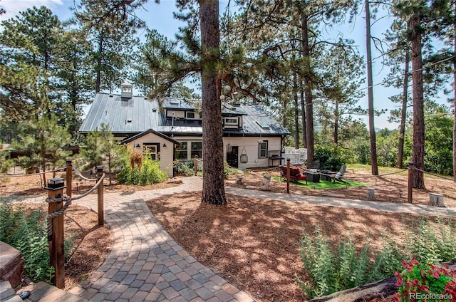 233 Perry Park Ave, Larkspur, CO 80118 - back of property with an outdoor fire pit and a metal roof