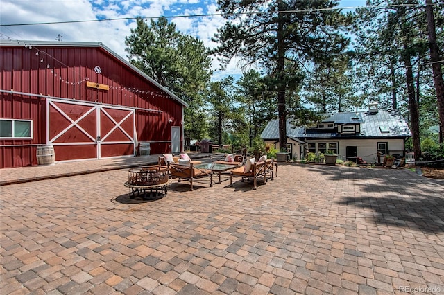 233 Perry Park Ave, Larkspur, CO 80118 - view of patio with an outdoor fire pit, a barn, and an outdoor structure