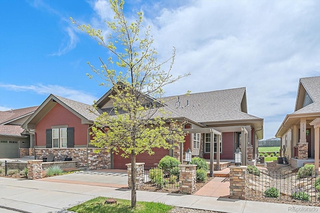 1130 Summit View Dr, Louisville, CO 80027 - view of front of home featuring driveway, a shingled roof, fence, and covered porch