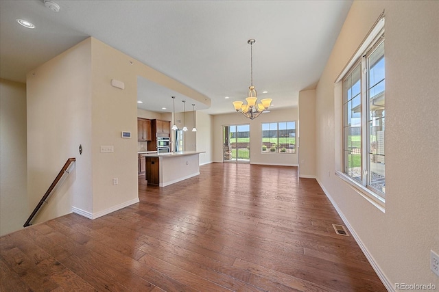 1130 Summit View Dr, Louisville, CO 80027 - unfurnished living room with a chandelier, dark wood finished floors, recessed lighting, and baseboards