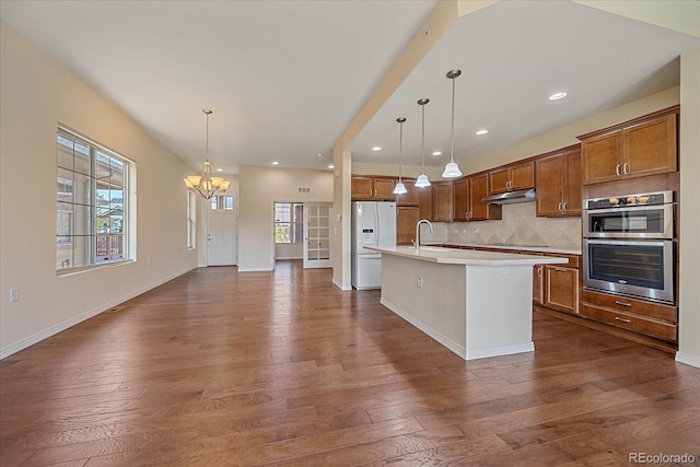 1130 Summit View Dr, Louisville, CO 80027 - kitchen featuring white fridge with ice dispenser, dark wood-type flooring, a chandelier, light countertops, and brown cabinets