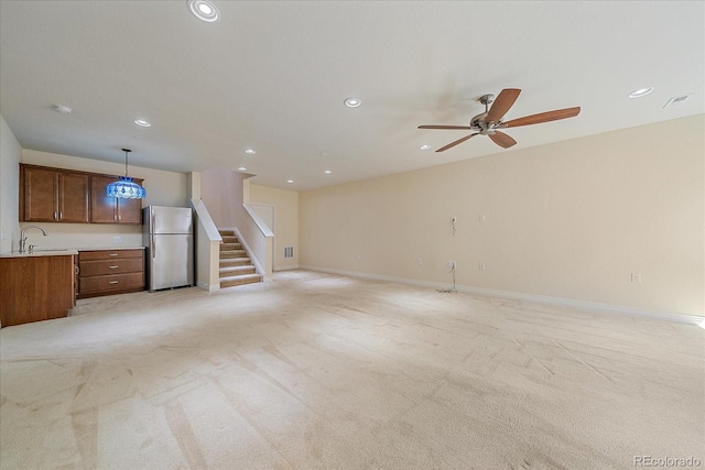 1130 Summit View Dr, Louisville, CO 80027 - unfurnished living room featuring light colored carpet, a sink, stairway, recessed lighting, and a ceiling fan