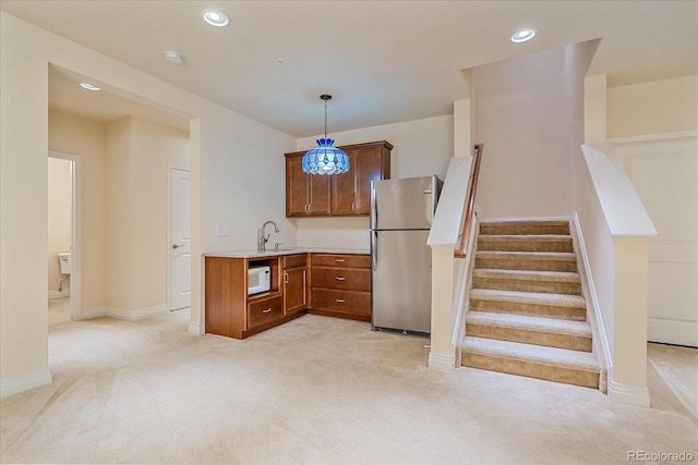 1130 Summit View Dr, Louisville, CO 80027 - kitchen with freestanding refrigerator, light carpet, light countertops, pendant lighting, and white microwave