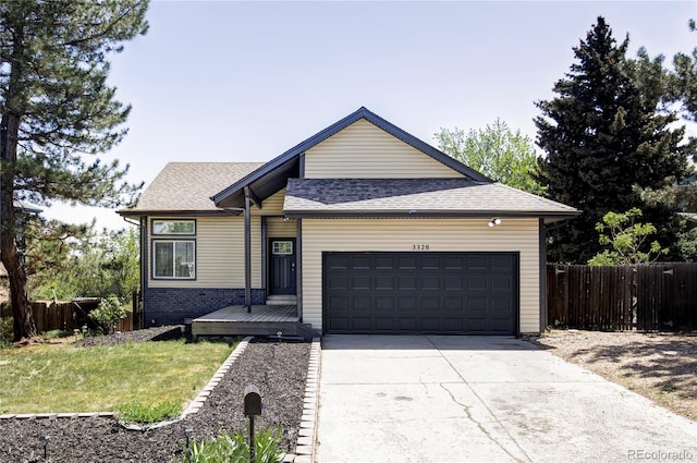 3328 S Danube St, Aurora, CO 80013 - view of front of house featuring a garage, driveway, and a shingled roof