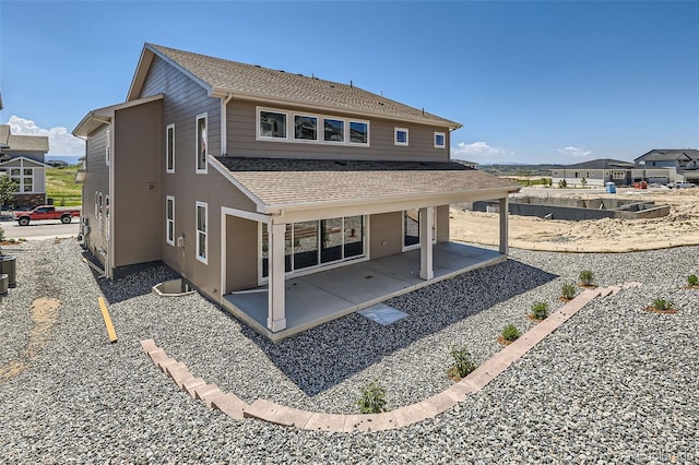 4748 Weitbrec Ln, Castle Rock, CO 80104 - back of house featuring roof with shingles and a patio
