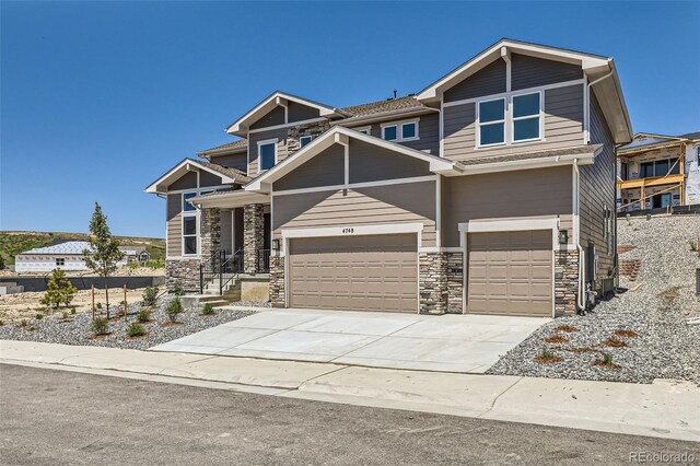 4748 Weitbrec Ln, Castle Rock, CO 80104 - craftsman house with stone siding, driveway, and a garage