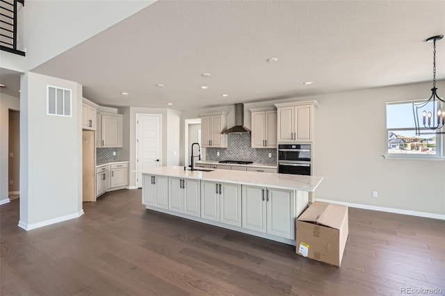4748 Weitbrec Ln, Castle Rock, CO 80104 - kitchen with wall chimney range hood, decorative backsplash, black gas cooktop, baseboards, and a chandelier