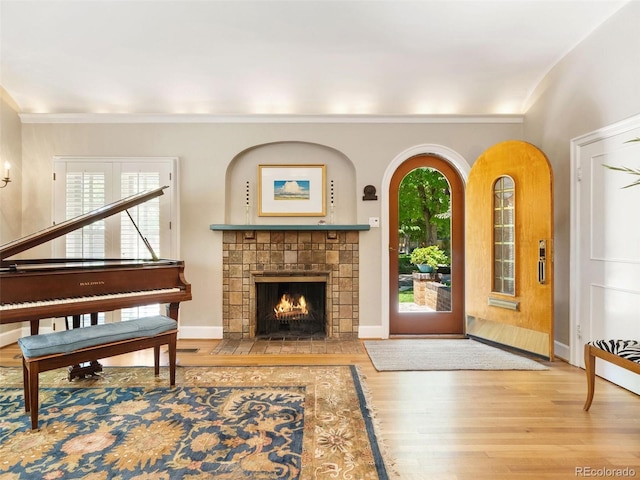 interior space featuring a tiled fireplace and hardwood / wood-style floors