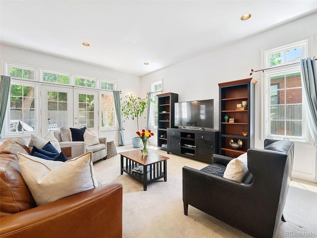 living room featuring french doors and light colored carpet