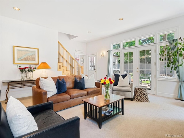 living room with french doors and light colored carpet