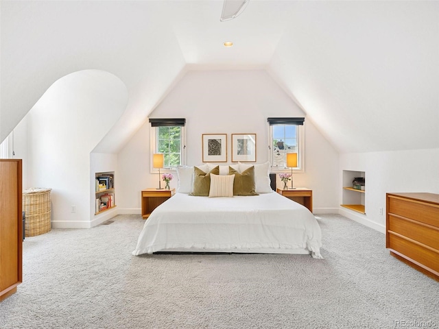 carpeted bedroom with lofted ceiling