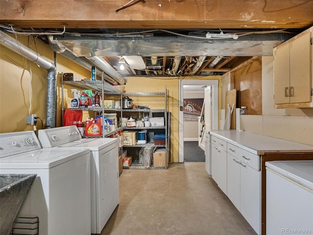 clothes washing area with cabinets, separate washer and dryer, and sink