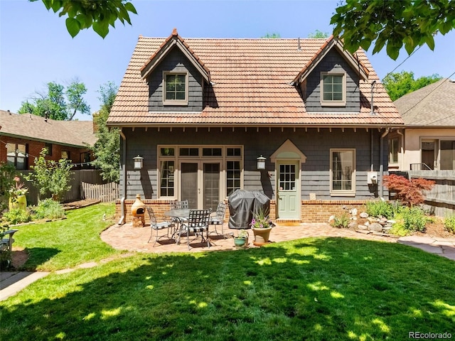 rear view of house with a yard and a patio area