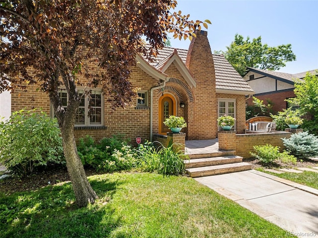 tudor home with a front yard