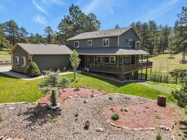 back of property with roof with shingles and a wooden deck