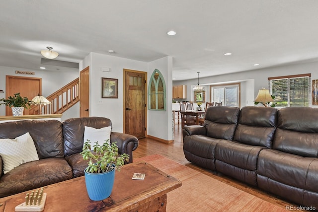 living area with wood finished floors, stairway, recessed lighting, and baseboards
