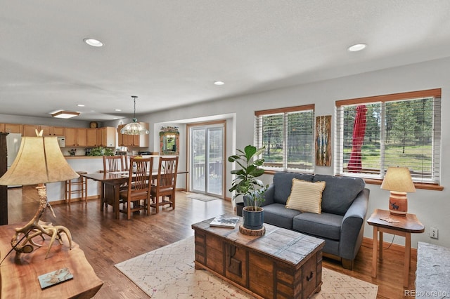 living room featuring wood finished floors, recessed lighting, and baseboards
