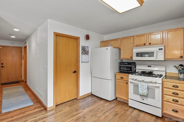 kitchen featuring white appliances, light wood-type flooring, light brown cabinets, baseboards, and tile countertops