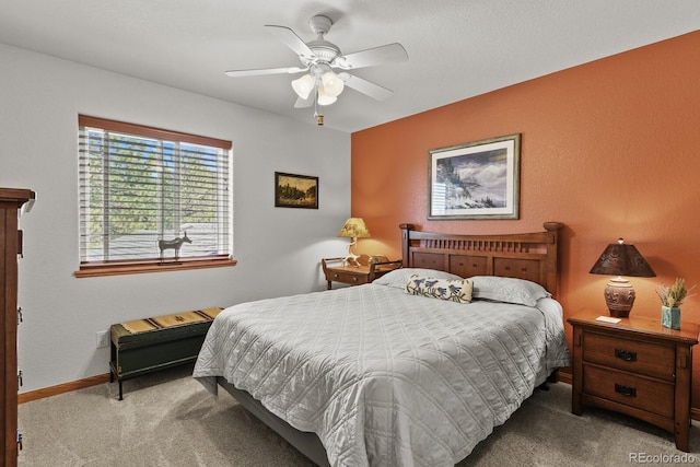 bedroom with carpet floors, a ceiling fan, and baseboards