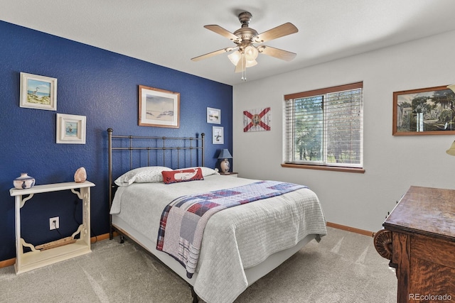 bedroom with carpet floors, baseboards, a textured wall, and a ceiling fan