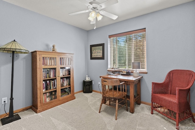 carpeted home office with a ceiling fan and baseboards