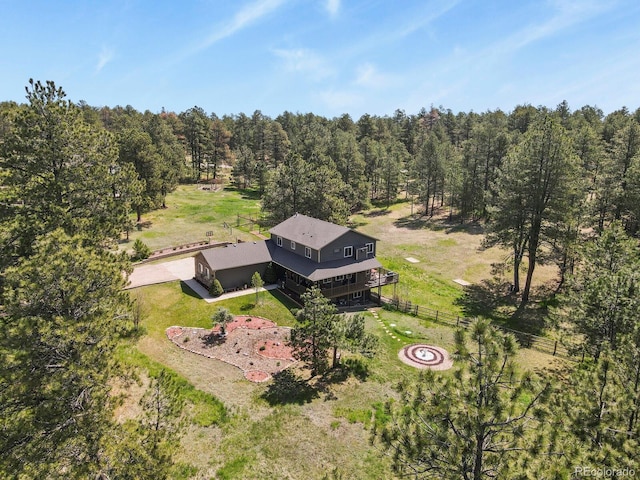 view from above of property with a heavily wooded area
