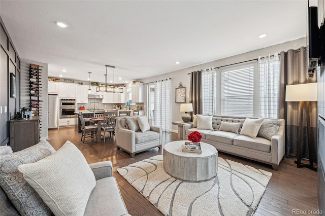 living room with wood finished floors and recessed lighting