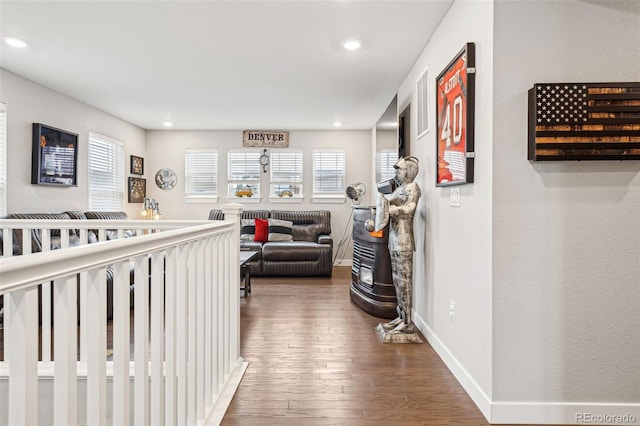 corridor featuring hardwood / wood-style flooring, baseboards, and recessed lighting