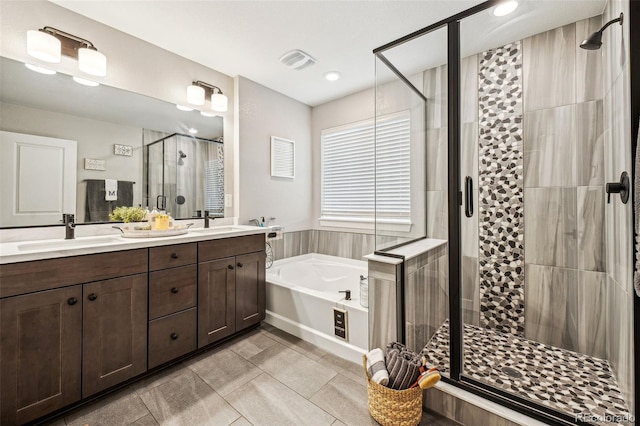 full bathroom with a garden tub, a shower stall, visible vents, and a sink