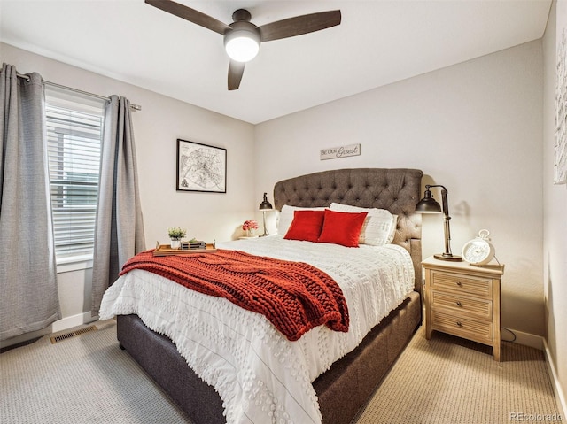 bedroom with light carpet, visible vents, a ceiling fan, and baseboards