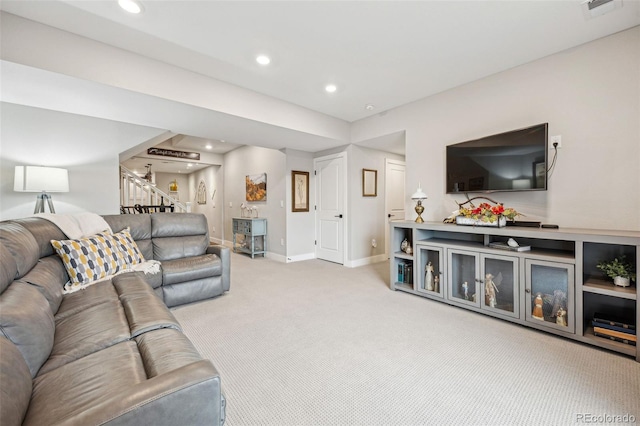 living area featuring recessed lighting, light carpet, baseboards, and stairs