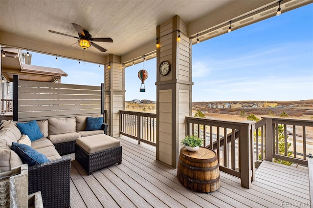 deck featuring ceiling fan and an outdoor hangout area