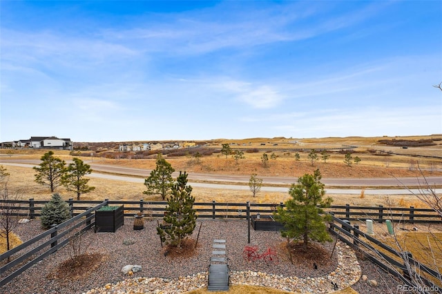 view of yard featuring a rural view and fence