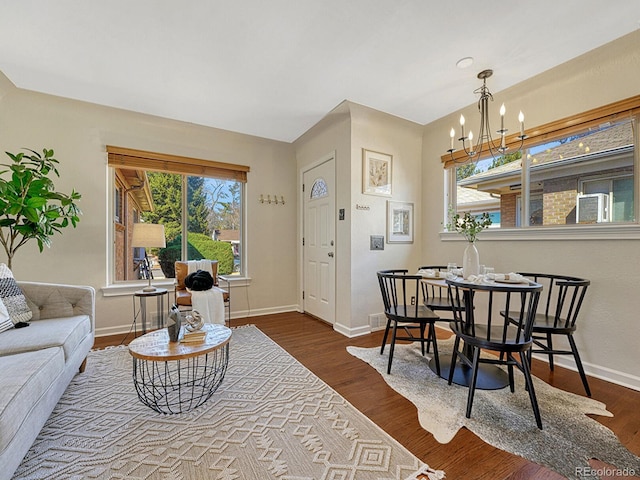 732 Poplar St, Denver, CO 80220 - living room featuring a chandelier, baseboards, and dark wood finished floors